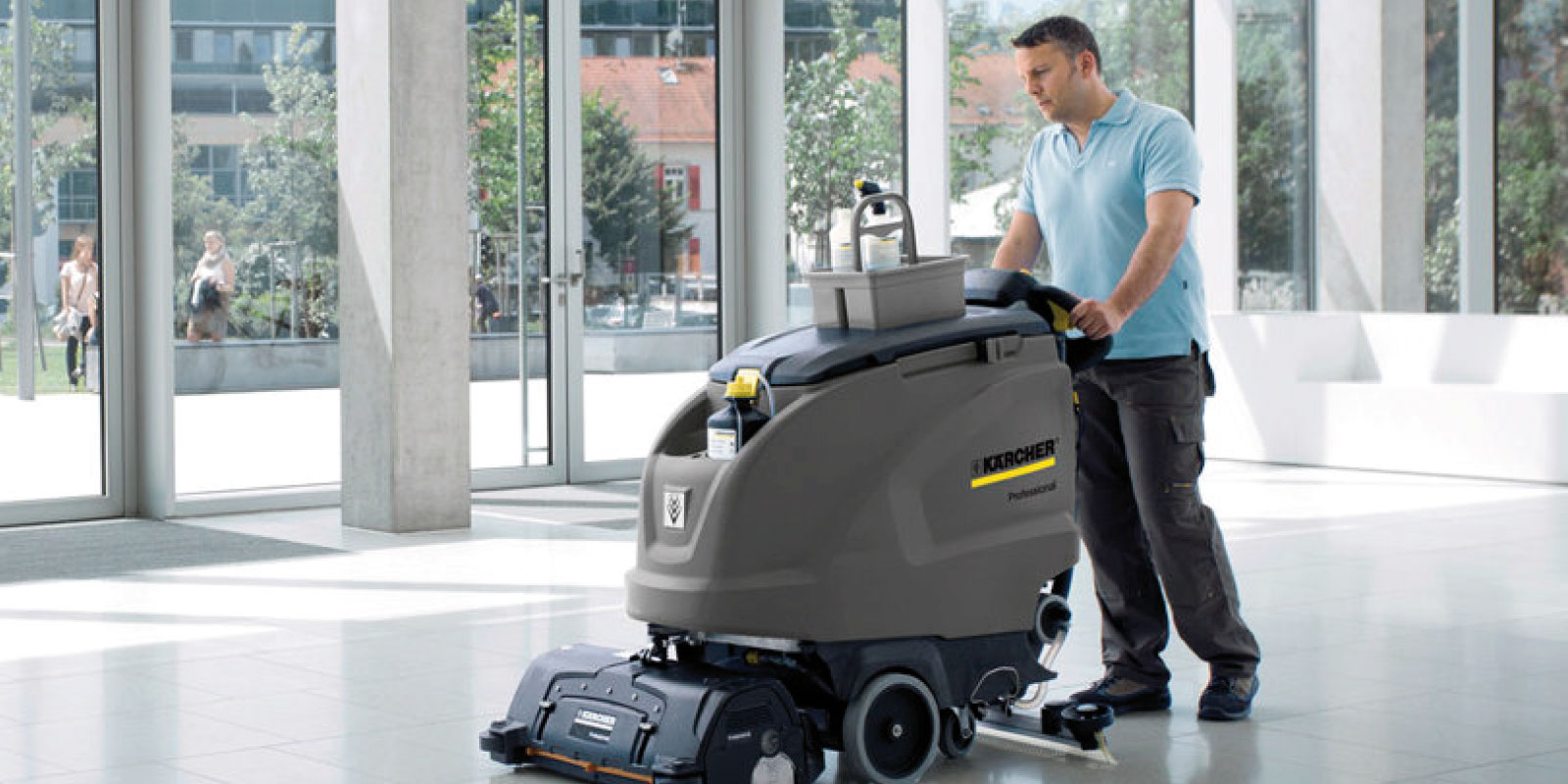 A picture of cleaning a lobby using a Kärcher walk-behind scrubber dryer.