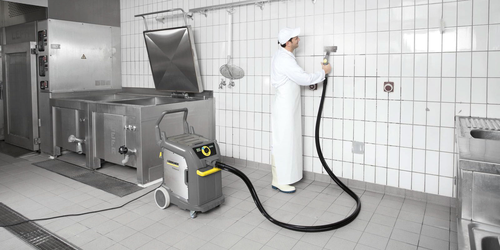 A picture of cleaning a kitchen using a Kärcher steam vacuum cleaner.
